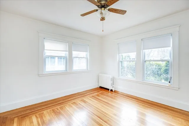 a view of a room with a window and ceiling fan