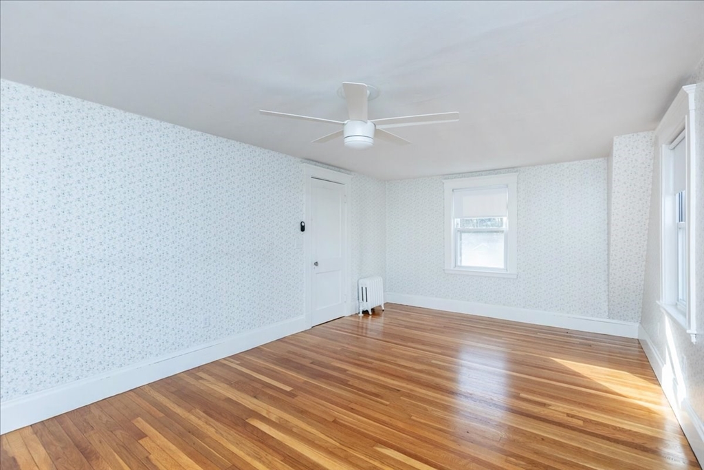 2 Martin Street Marblehead, MA 01945 - Photo 21 of 40 an empty room with wooden floor ceiling fan and windows