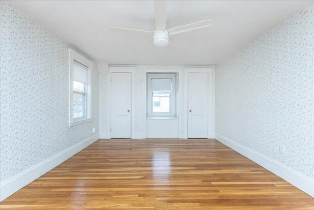 a view of an empty room with wooden floor