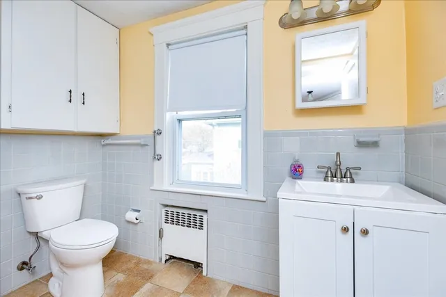 a bathroom with a sink mirror and toilet