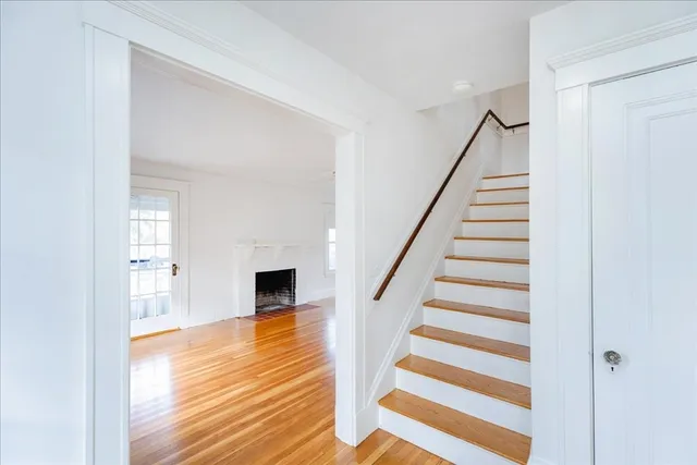 a view of a living room with wooden floor and staircase