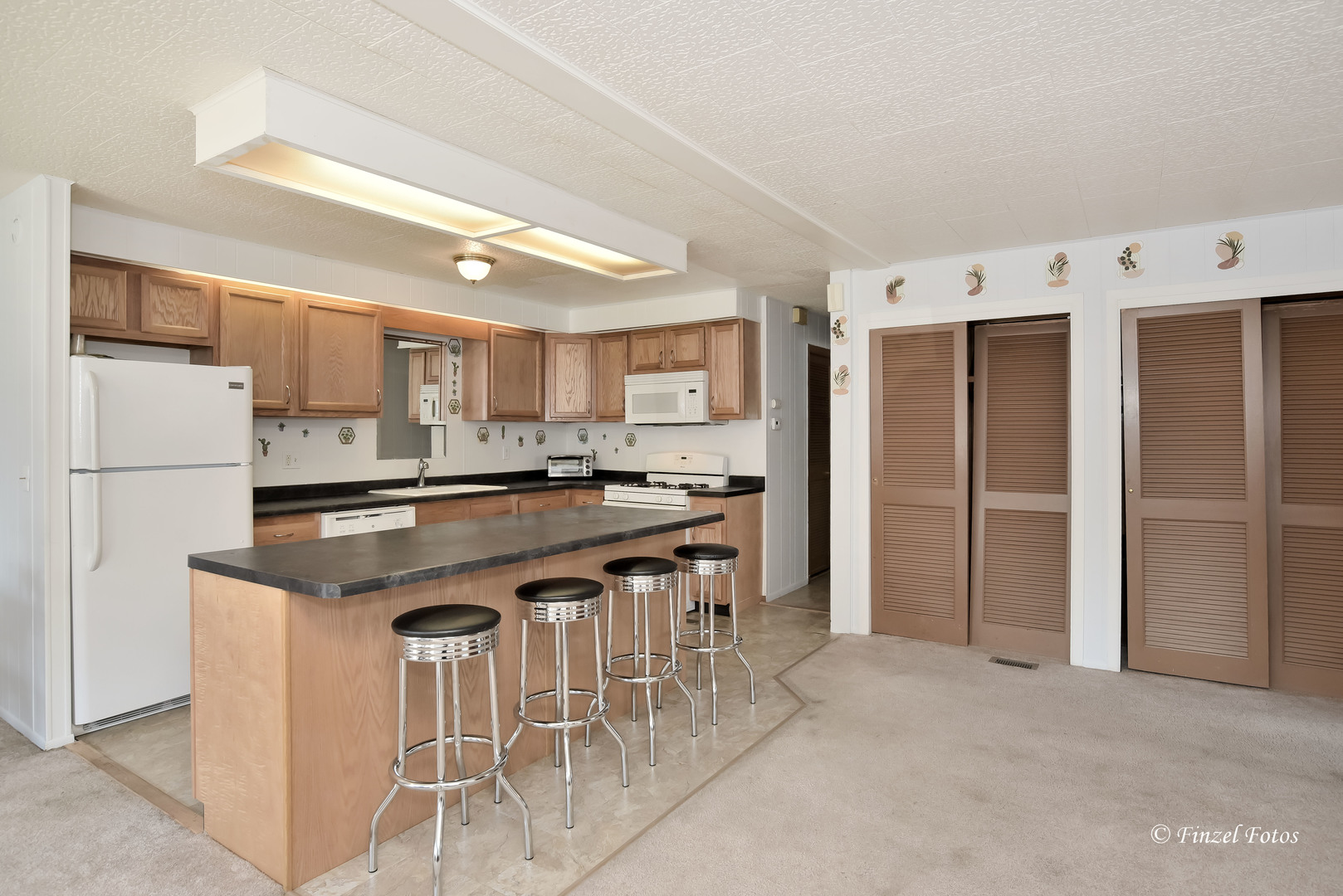 1158 Country Club Road Elgin, IL 60123 - Photo 7 of 16 a kitchen with stainless steel appliances granite countertop a stove and a refrigerator