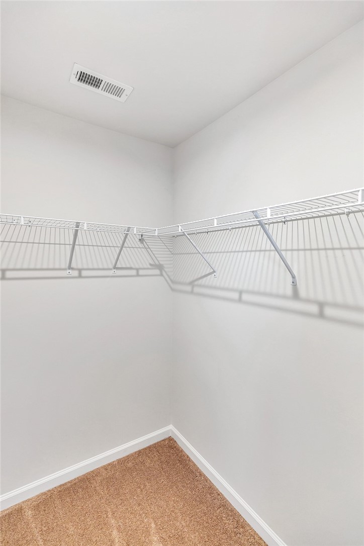 150 Queens Mill Court Pendleton, SC 29670 - Photo 16 of 37 This spacious closet features ample shelving for organized storage, complete with soft carpeting underfoot.