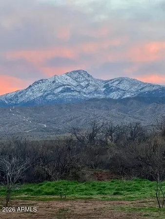 a view of mountain with sunset in background