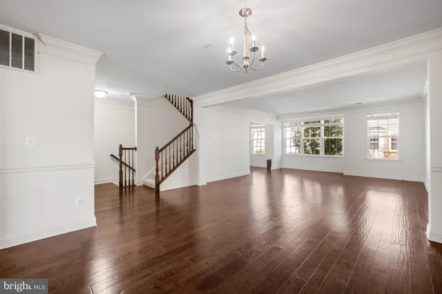 a view of an room with wooden floors and windows