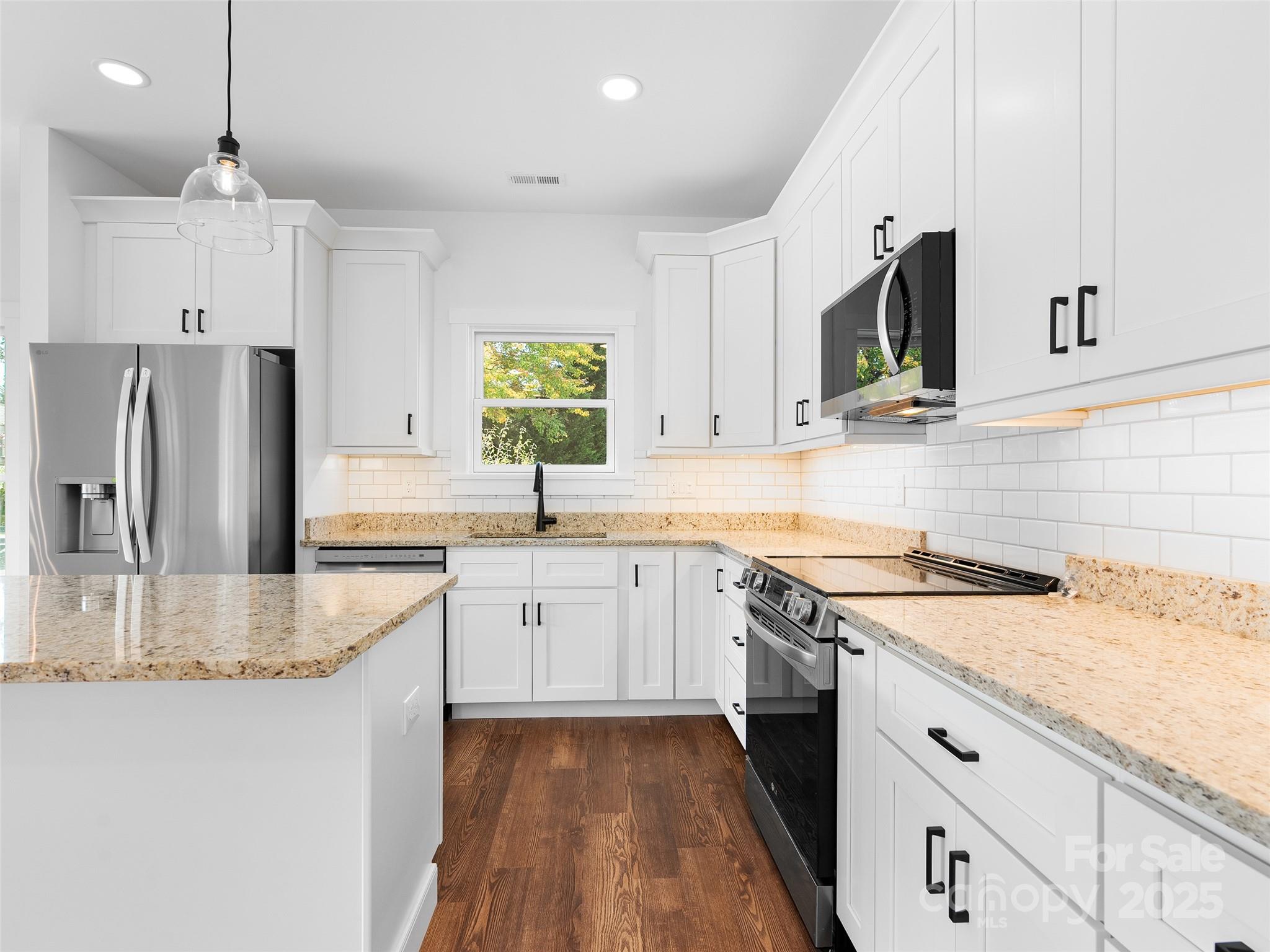 11 Riemar Lane Waynesville, NC 28786 - Photo 22 of 37 a kitchen with granite countertop a sink stainless steel appliances and white cabinets