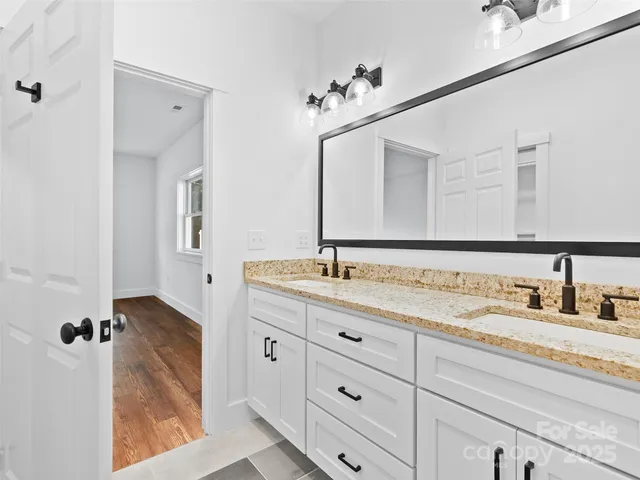 a bathroom with a double vanity sink and mirror