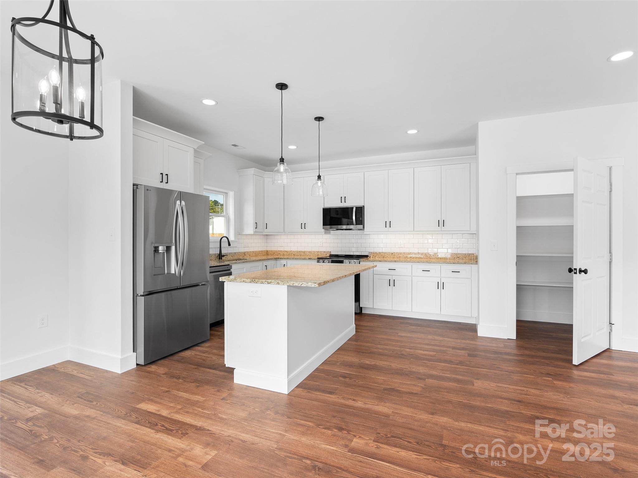 11 Riemar Lane Waynesville, NC 28786 - Photo 5 of 37 a large kitchen with a refrigerator and a stove top oven