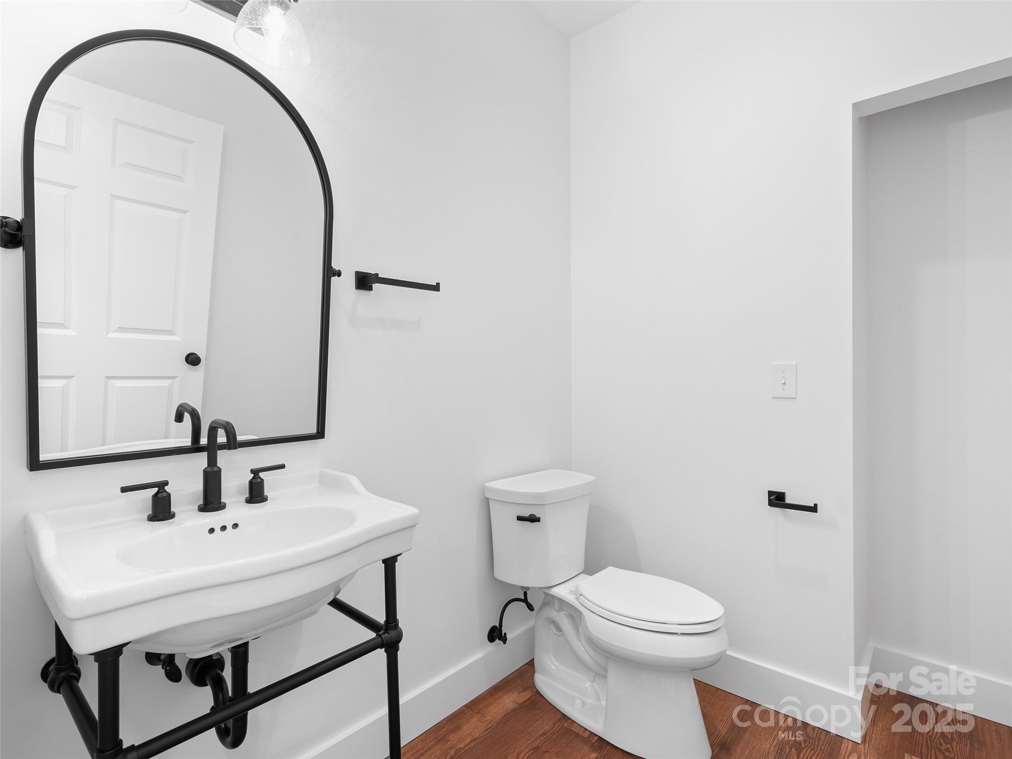 11 Riemar Lane Waynesville, NC 28786 - Photo 9 of 37 a bathroom with a sink a toilet and a mirror