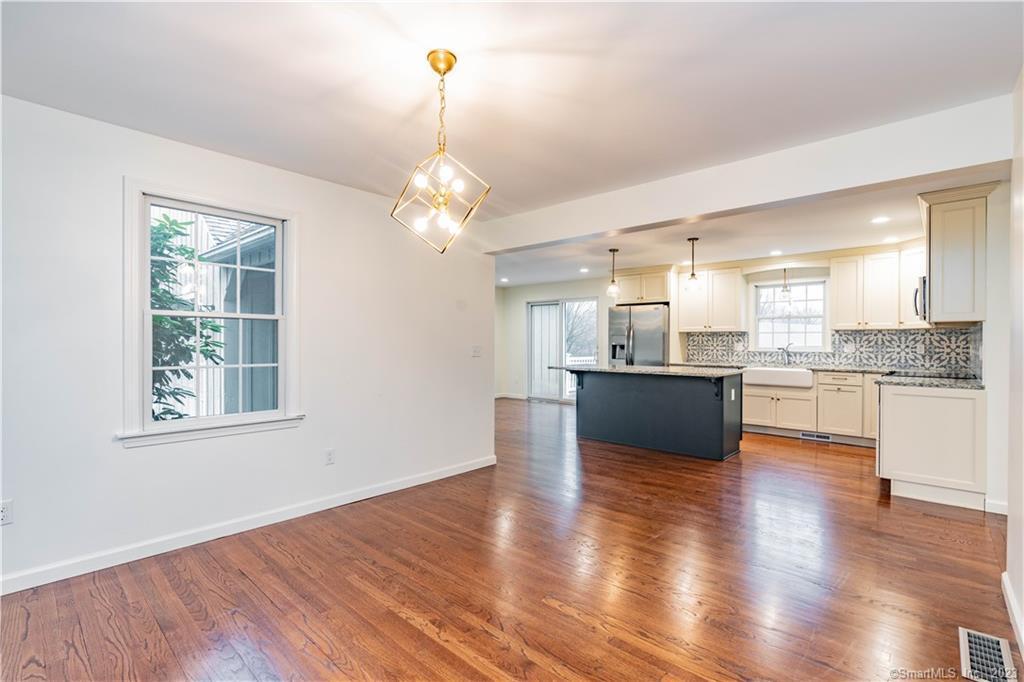 1241 Halladay Avenue West Suffield, CT 06078 - Photo 8 of 29 a view of a kitchen center island wooden floor and stainless steel appliances