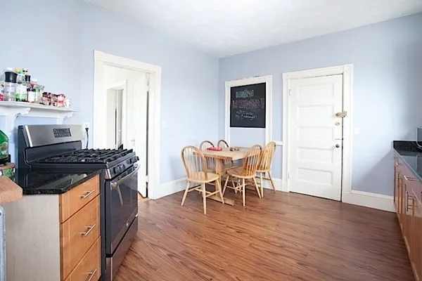a dining room with a table chairs and a stove