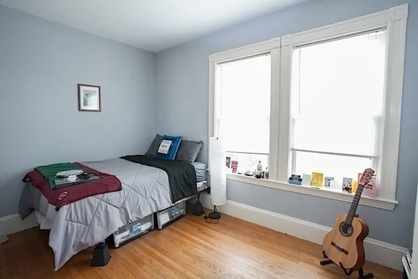 a bedroom with a bed and a window