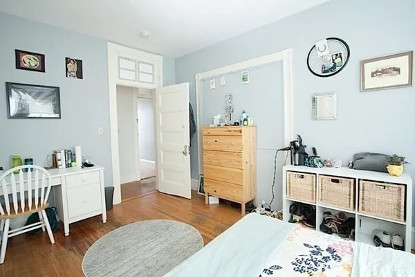 a bedroom with furniture and a wooden floor