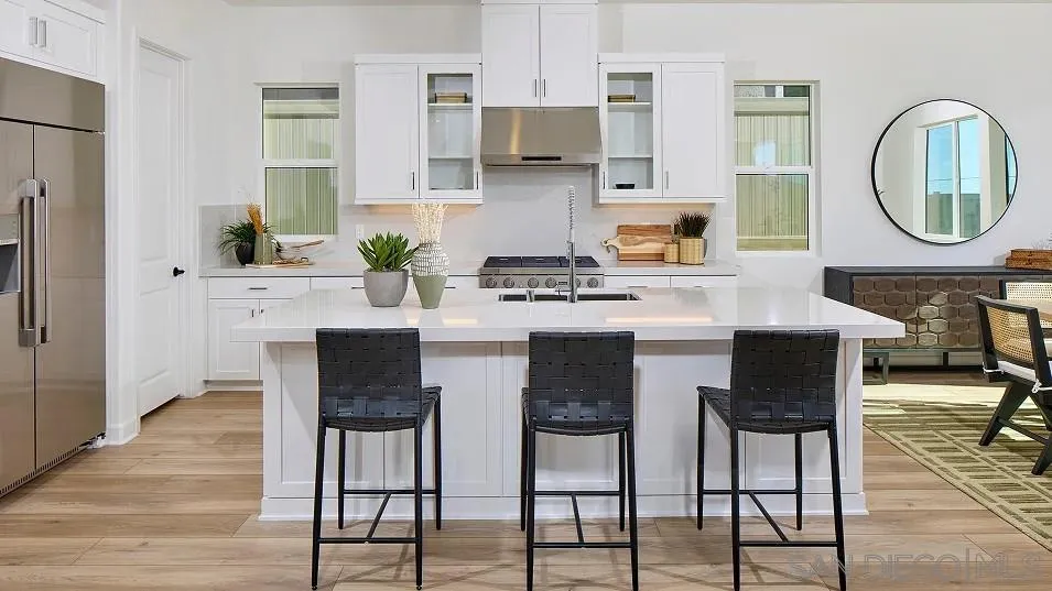 2312 Loker Way Oceanside, CA 92054 - Photo 11 of 20 a kitchen with stainless steel appliances granite countertop a stove a sink a dining table and chairs