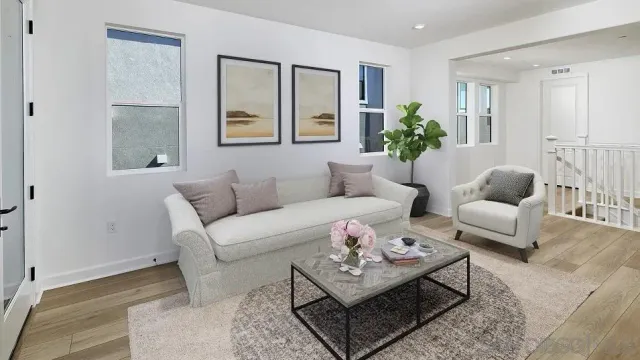 a living room with furniture a rug and a window
