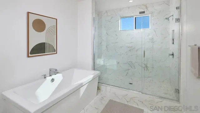 a bathroom with a sink a mirror and shower