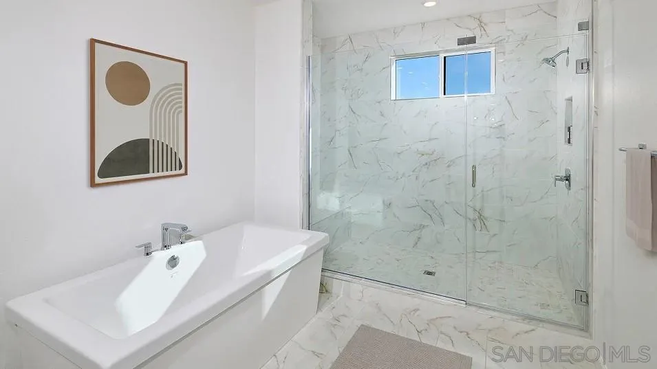 2312 Loker Way Oceanside, CA 92054 - Photo 16 of 20 a bathroom with a sink a mirror and shower