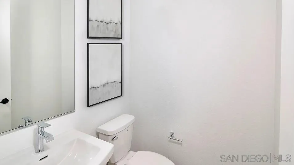 2312 Loker Way Oceanside, CA 92054 - Photo 19 of 20 a bathroom with a toilet sink and mirror