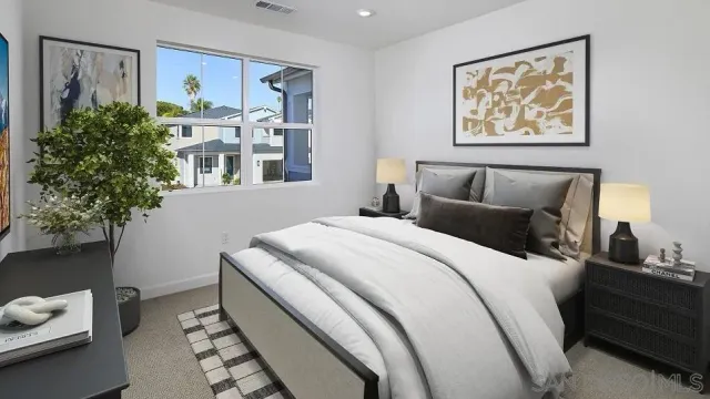 a bed room with a bed and a painting on the wall