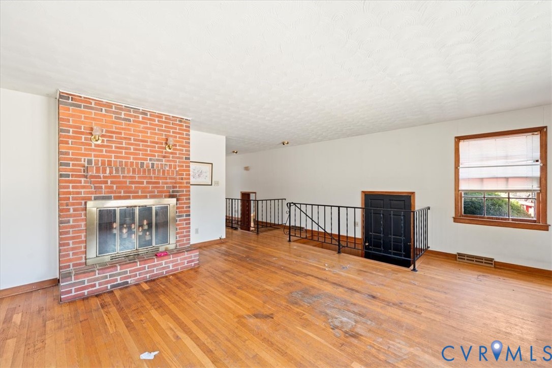 10401 Carriage Road Providence Forge, VA 23140 - Photo 13 of 30 a view of an empty room with wooden floor and a window