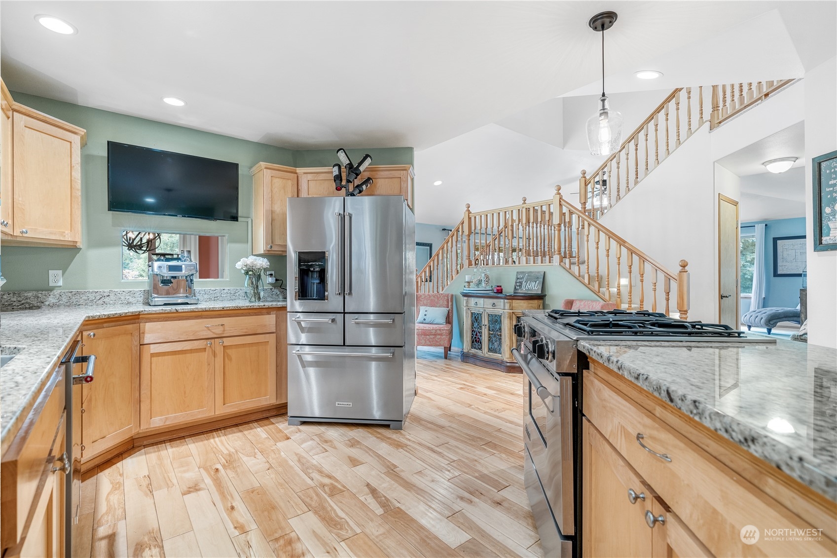 2109 Grove Road Northwest Olympia, WA 98502 - Photo 12 of 40 a kitchen with stainless steel appliances granite countertop a refrigerator a stove a sink dishwasher a oven with white cabinets and wooden floor