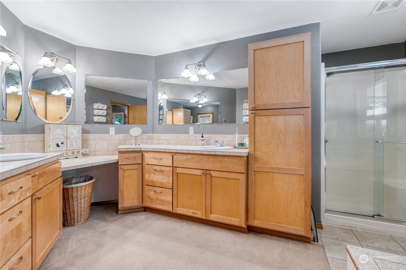 2109 Grove Road Northwest Olympia, WA 98502 - Photo 20 of 40 a spacious bathroom with a shower sink and mirror