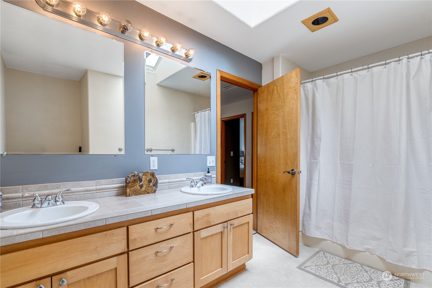 2109 Grove Road Northwest Olympia, WA 98502 - Photo 27 of 40 a bathroom with a sink and a mirror