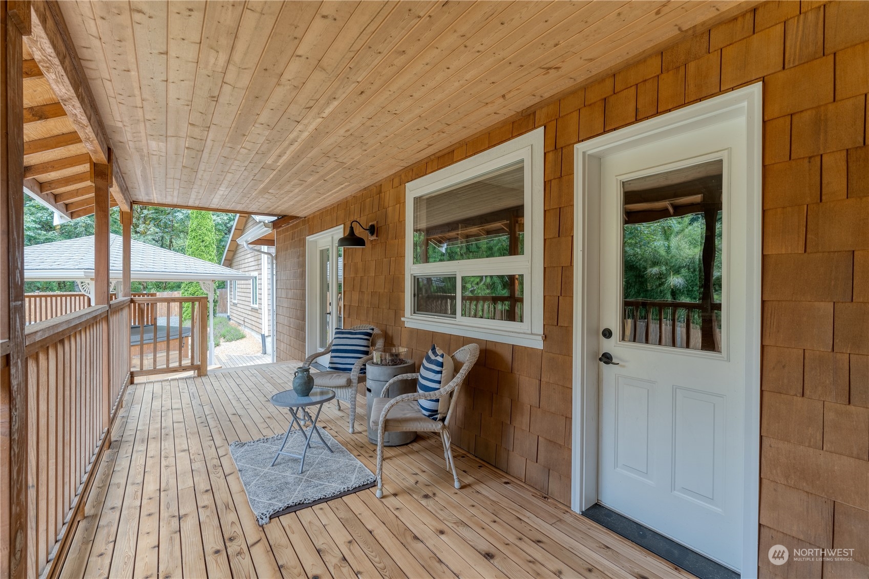 2109 Grove Road Northwest Olympia, WA 98502 - Photo 30 of 40 a balcony with wooden floor and outdoor seating