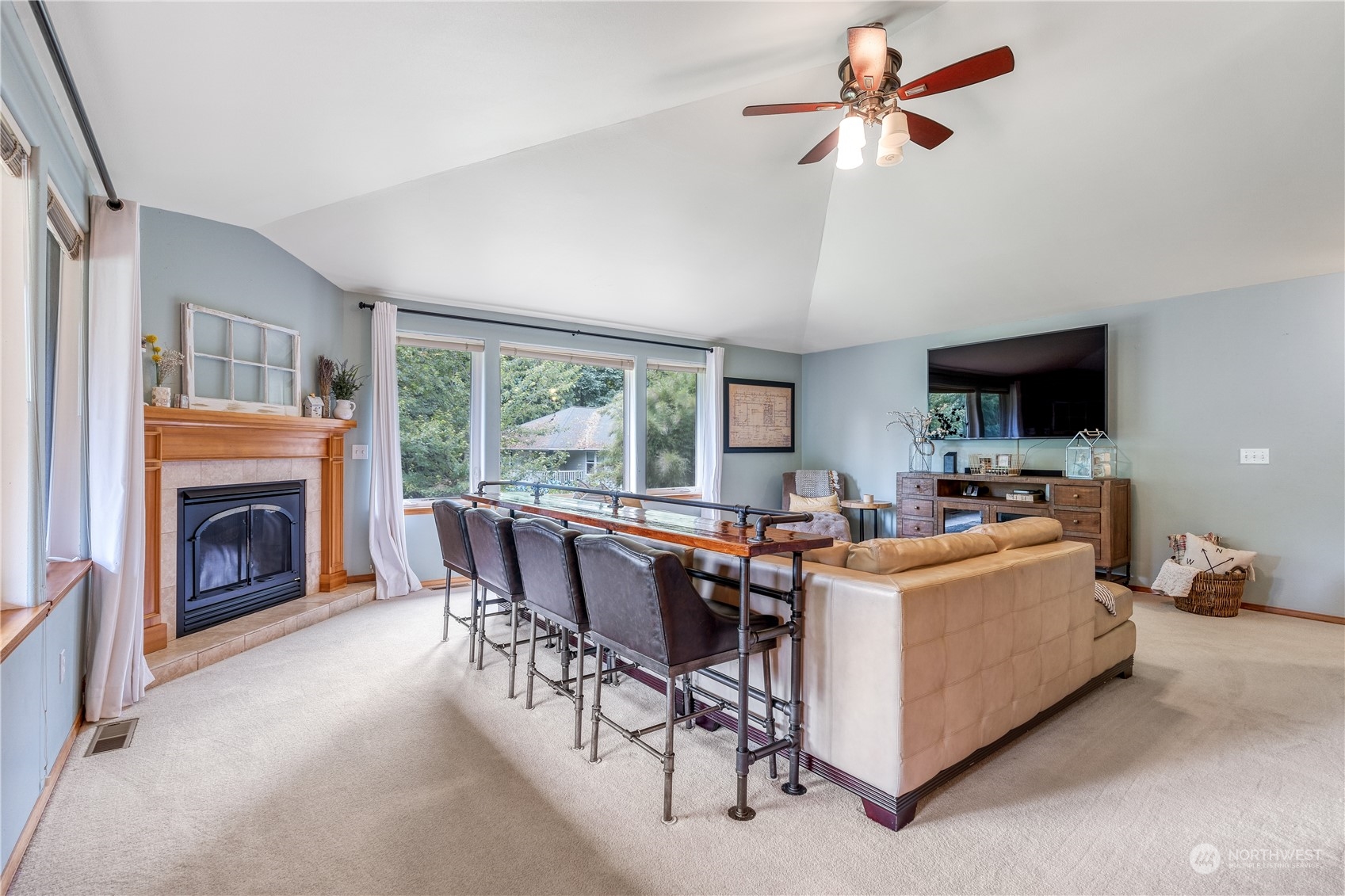 2109 Grove Road Northwest Olympia, WA 98502 - Photo 6 of 40 a living room with furniture a fireplace and a flat screen tv