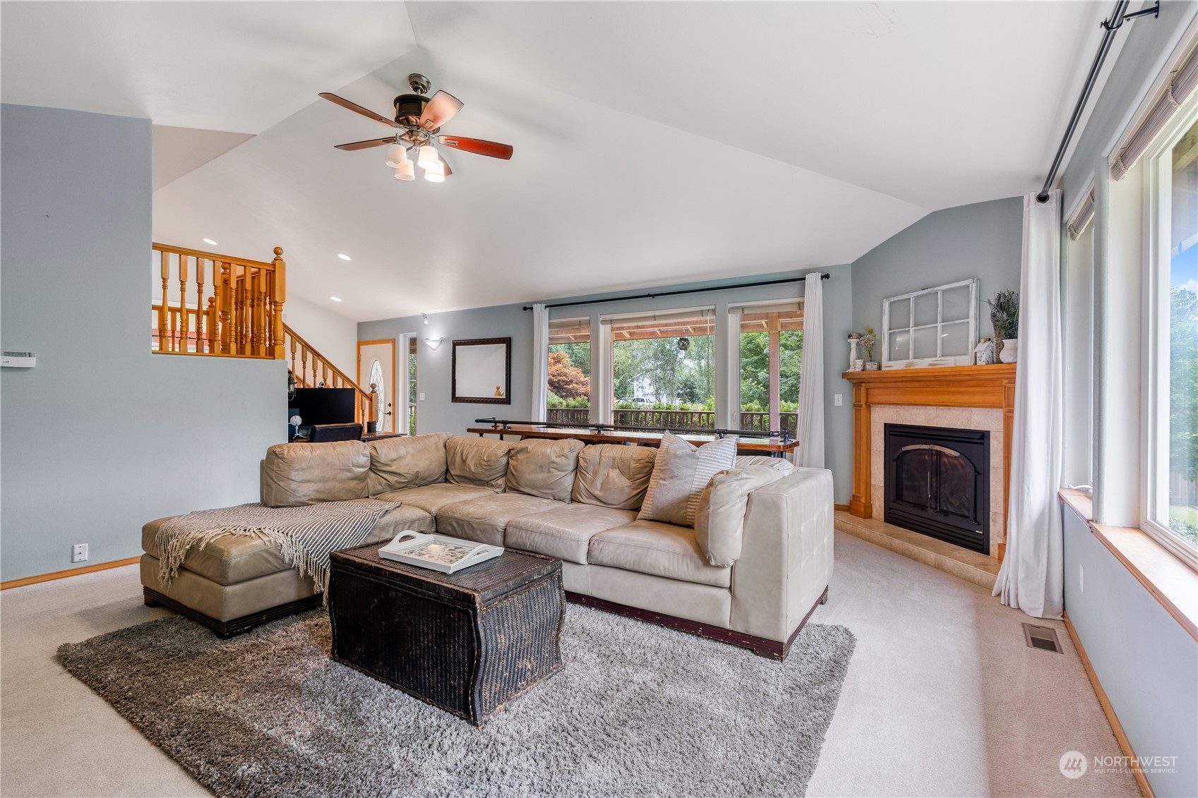 2109 Grove Road Northwest Olympia, WA 98502 - Photo 8 of 40 a living room with furniture a large window and a fireplace