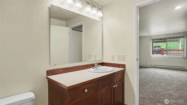 a bathroom with a sink a vanity and a mirror
