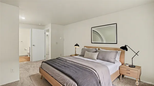 a bedroom with a bed and a painting on the wall