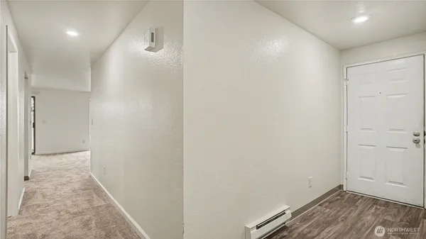 a view of hallway with wooden floor