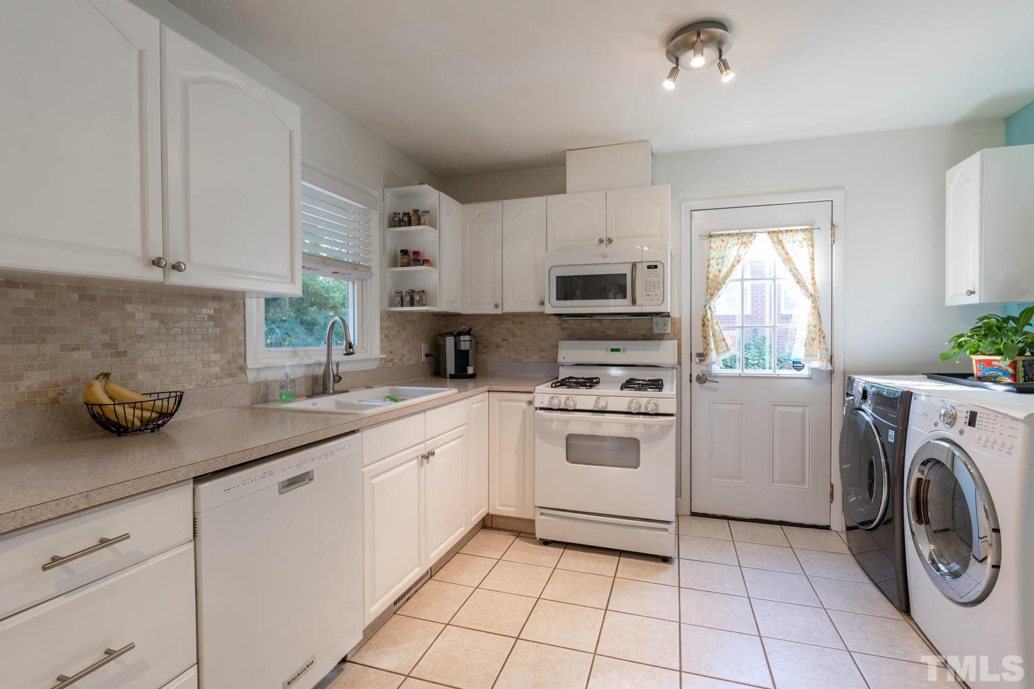 3137 Brentwood Road Raleigh, NC 27604 - Photo 14 of 19 a kitchen with cabinets a washer and dryer