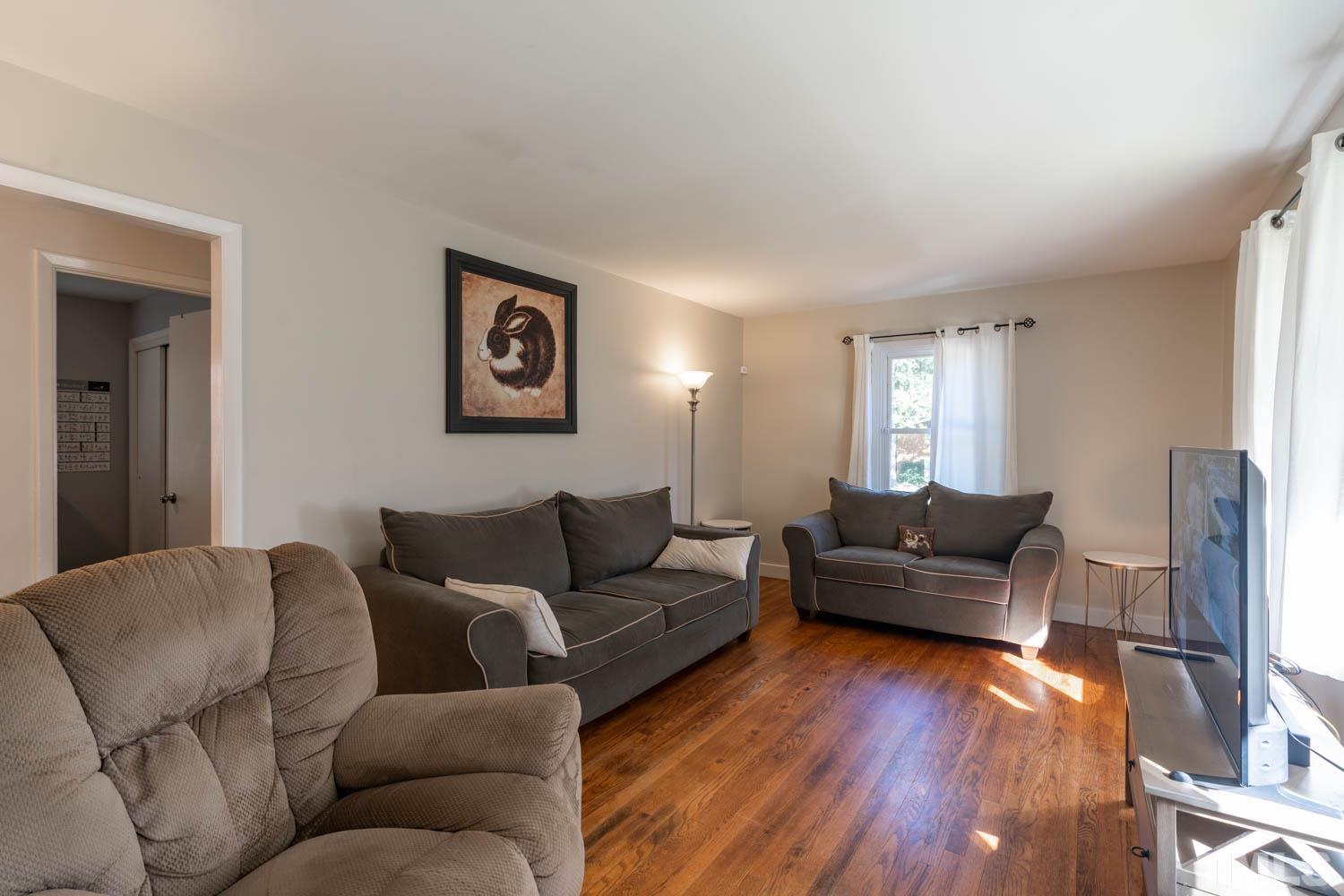 3137 Brentwood Road Raleigh, NC 27604 - Photo 4 of 19 a living room with furniture and a wooden floor