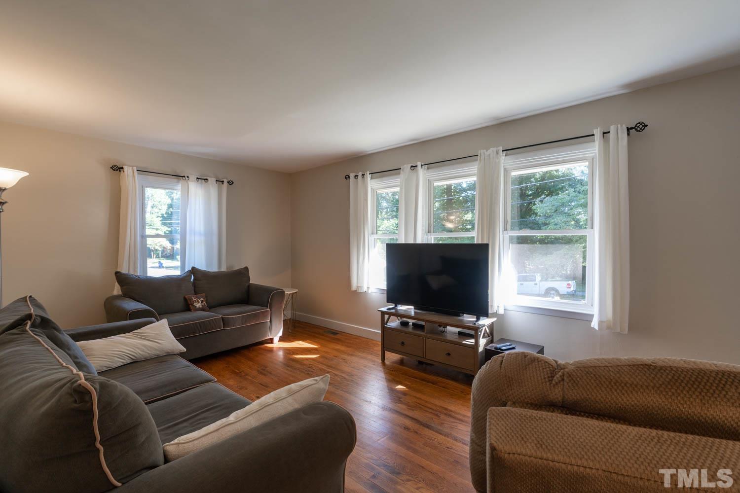 3137 Brentwood Road Raleigh, NC 27604 - Photo 5 of 19 a living room with furniture and a flat screen tv