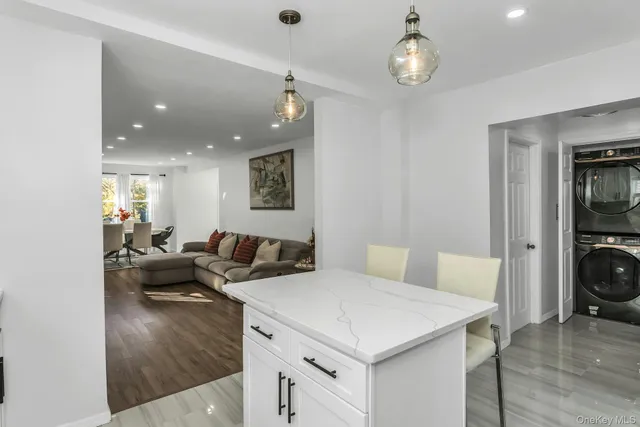 a view of a kitchen area with furniture and wooden floor