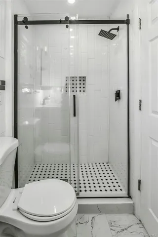 a bathroom with a shower a toilet and a shower