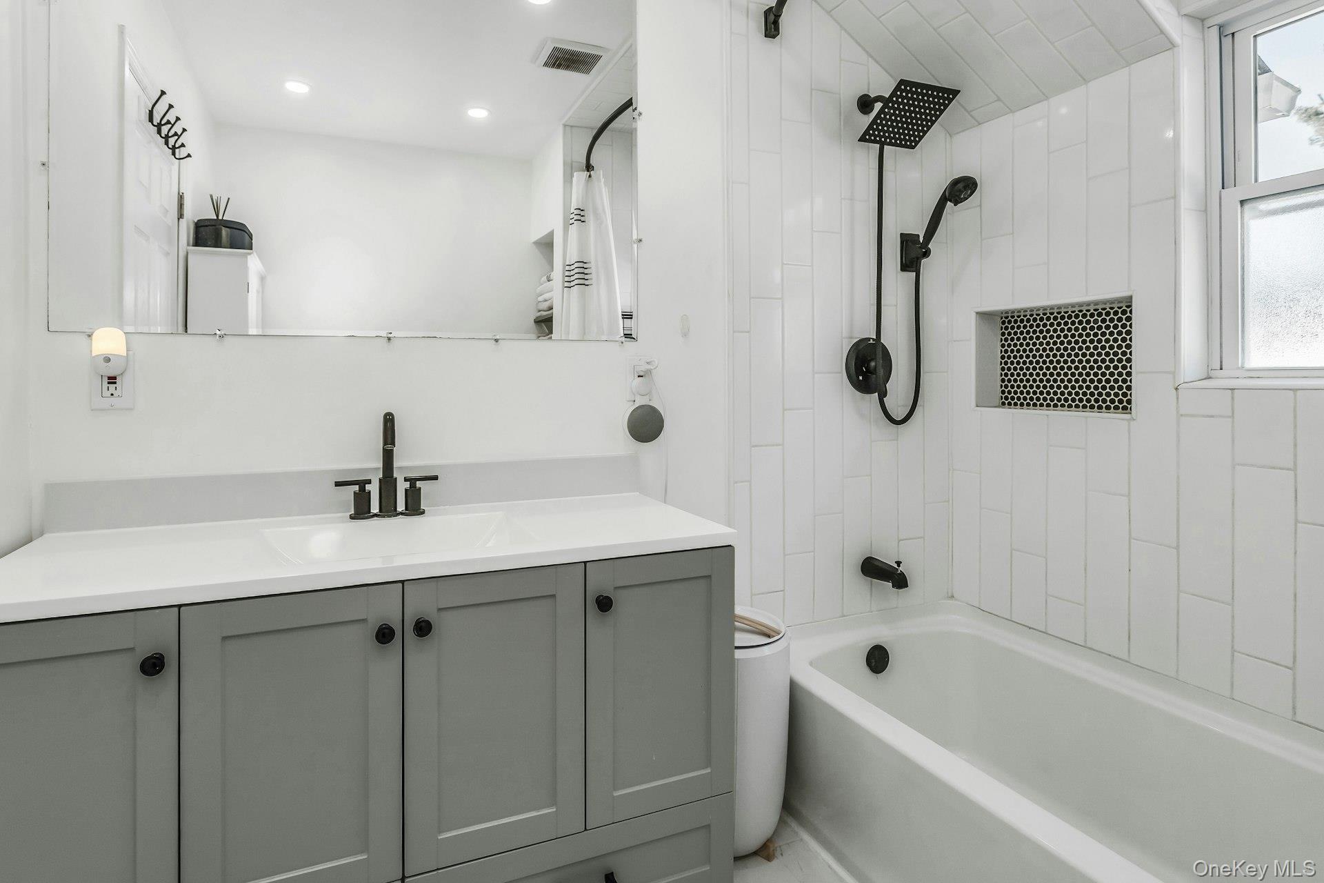 42 13th Street Locust Valley, NY 11560 - Photo 23 of 34 Bathroom featuring vanity and shower / tub combination