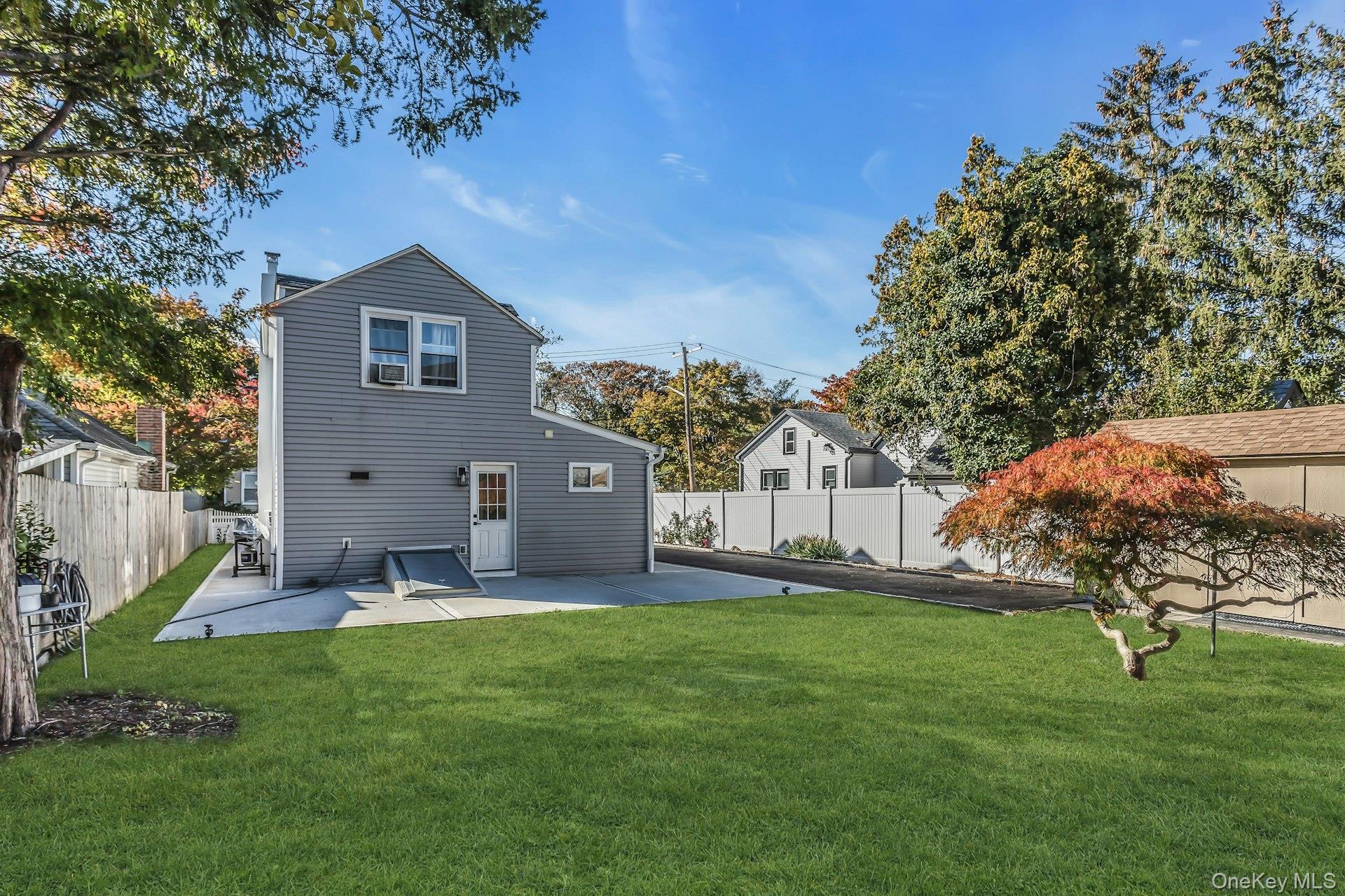 42 13th Street Locust Valley, NY 11560 - Photo 29 of 34 Back of property featuring a patio and a fenced backyard