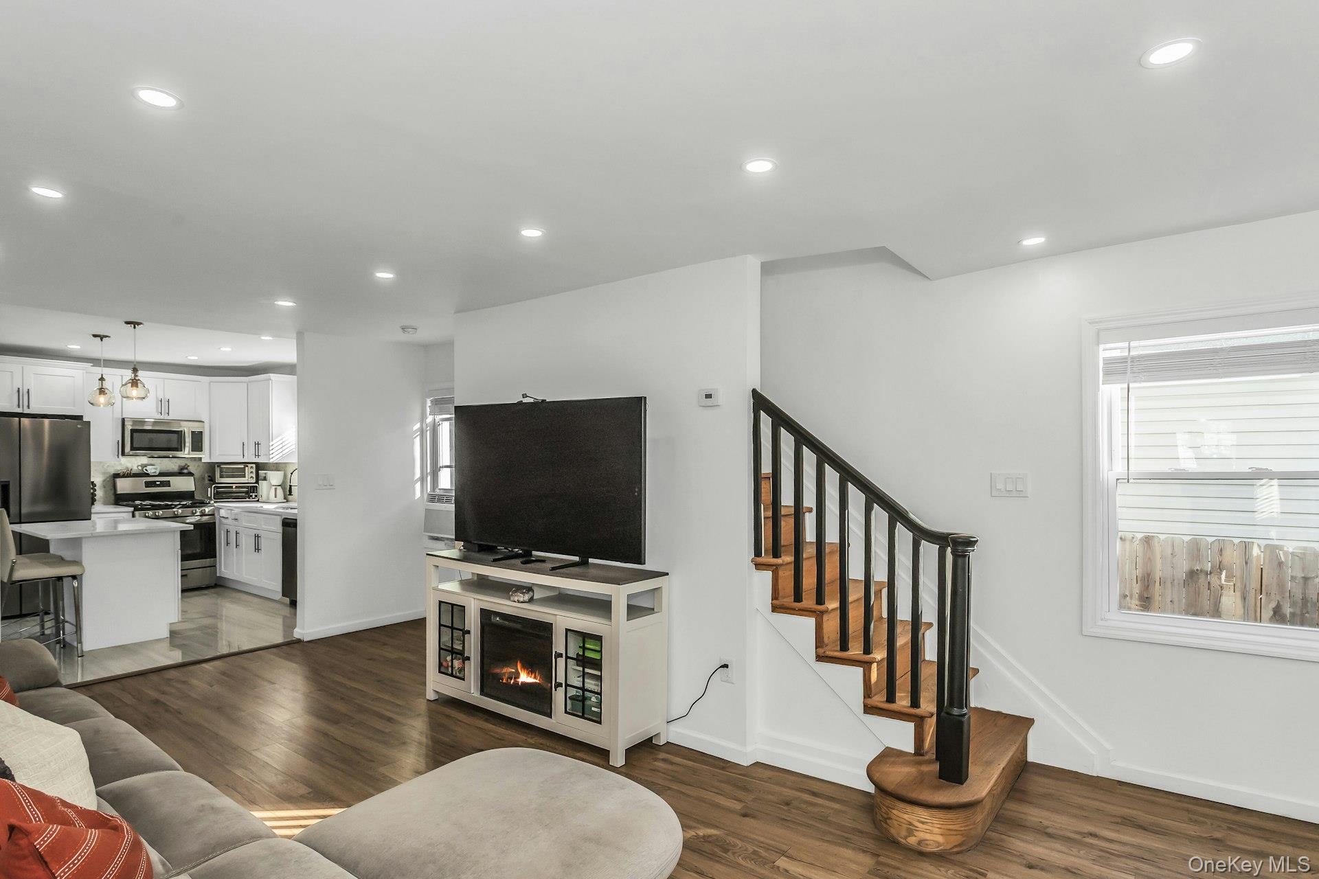 42 13th Street Locust Valley, NY 11560 - Photo 9 of 34 Living area with dark wood-style flooring, recessed lighting, and stairs