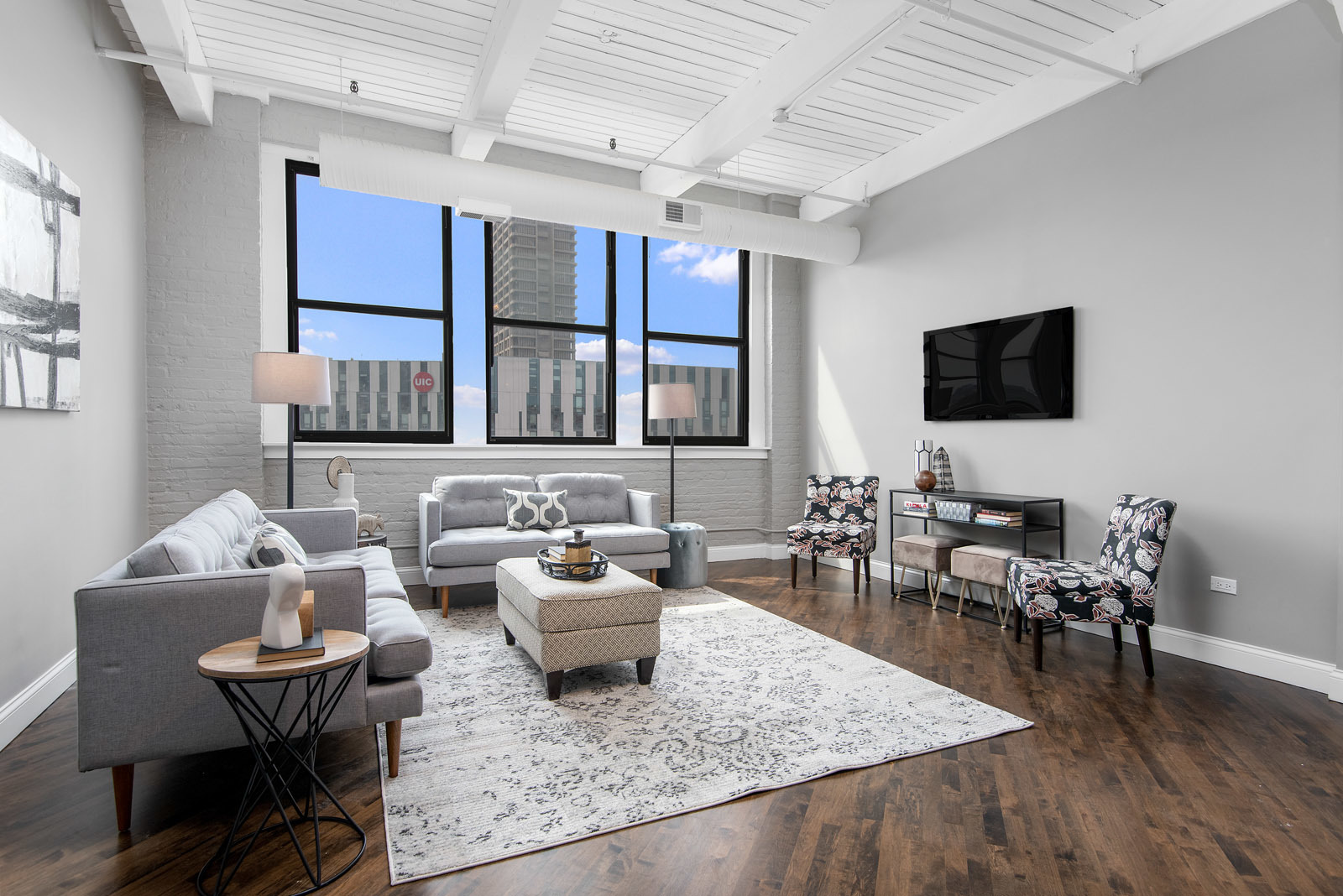 411 South Sangamon Street, Unit 7C Chicago, IL 60607 - Photo 4 of 15 a living room with furniture and a flat screen tv