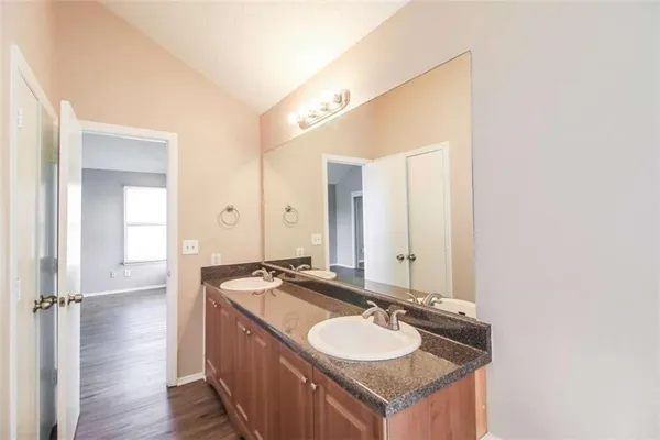 a bathroom with a granite countertop sink and a mirror