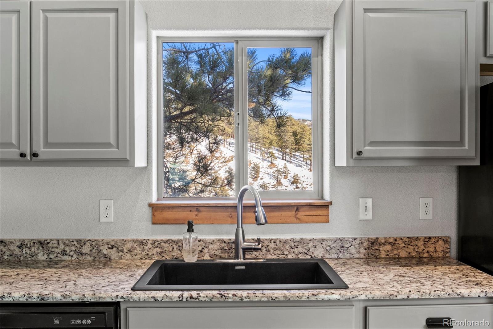 200 Virginia Road Bailey, CO 80421 - Photo 13 of 49 a kitchen with granite countertop a sink and a window
