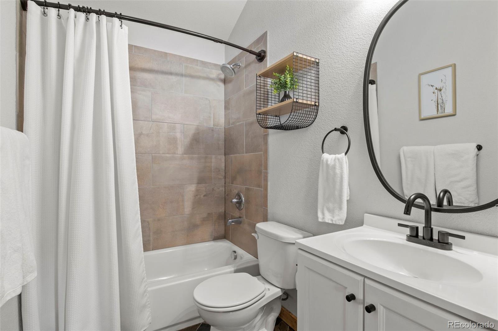 200 Virginia Road Bailey, CO 80421 - Photo 17 of 49 a bathroom with a sink a toilet and shower