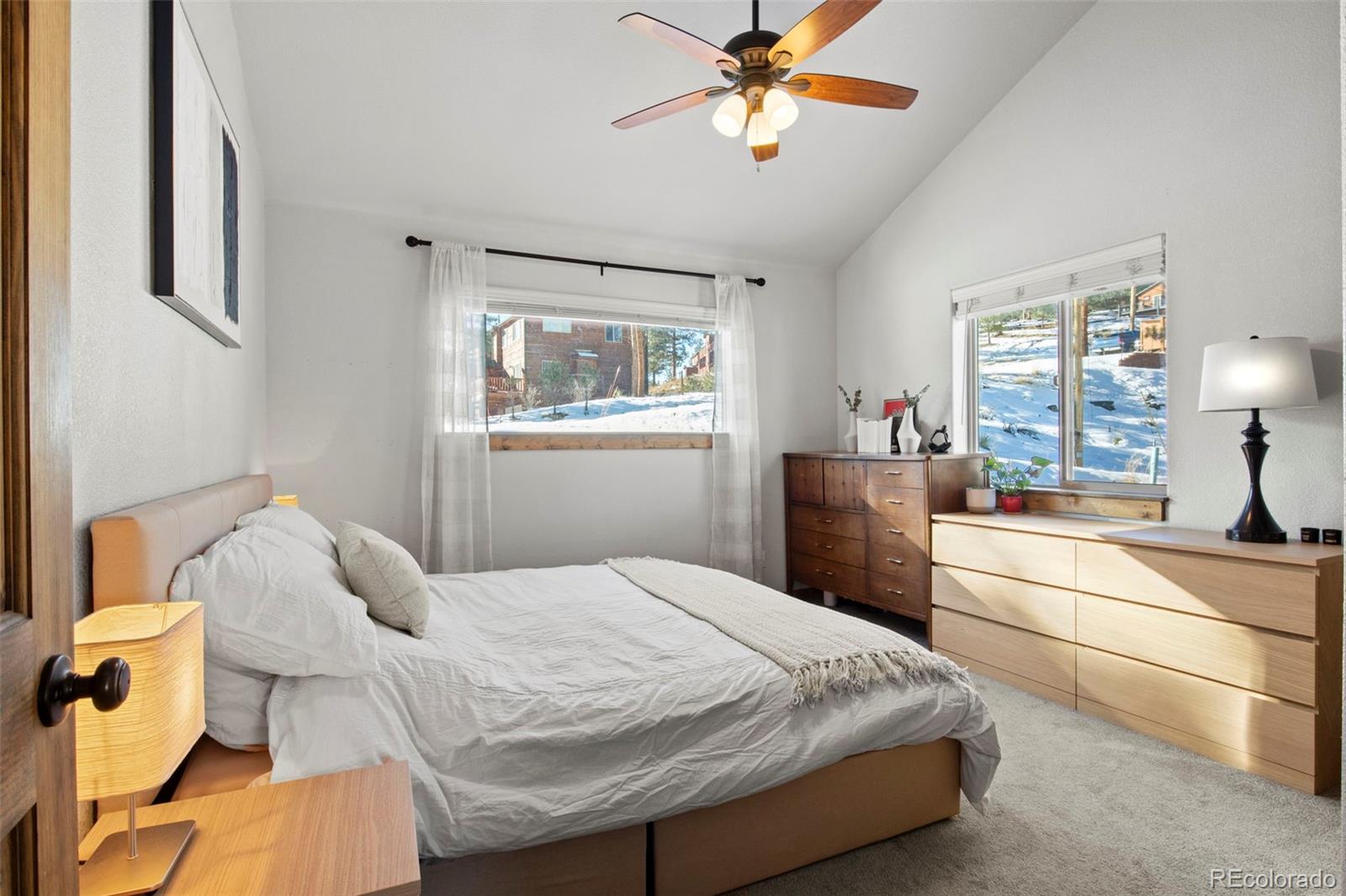 200 Virginia Road Bailey, CO 80421 - Photo 18 of 49 a bedroom with a bed and a chandelier