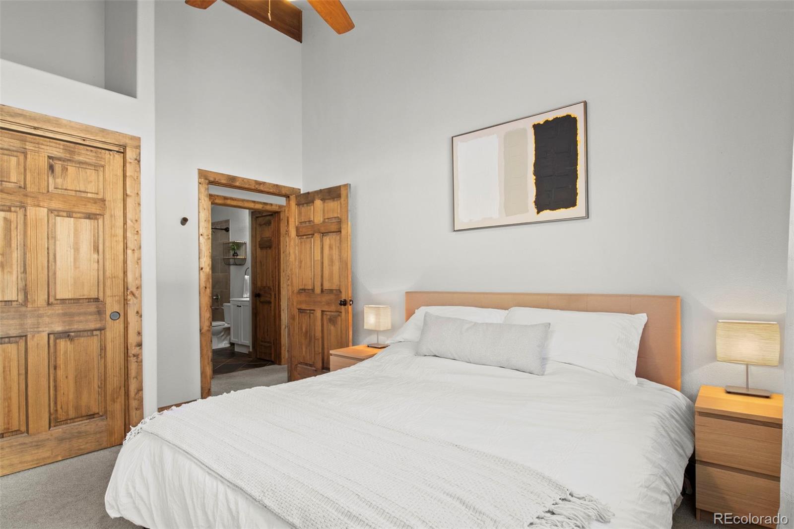 200 Virginia Road Bailey, CO 80421 - Photo 21 of 49 a bedroom with a bed and wooden floor