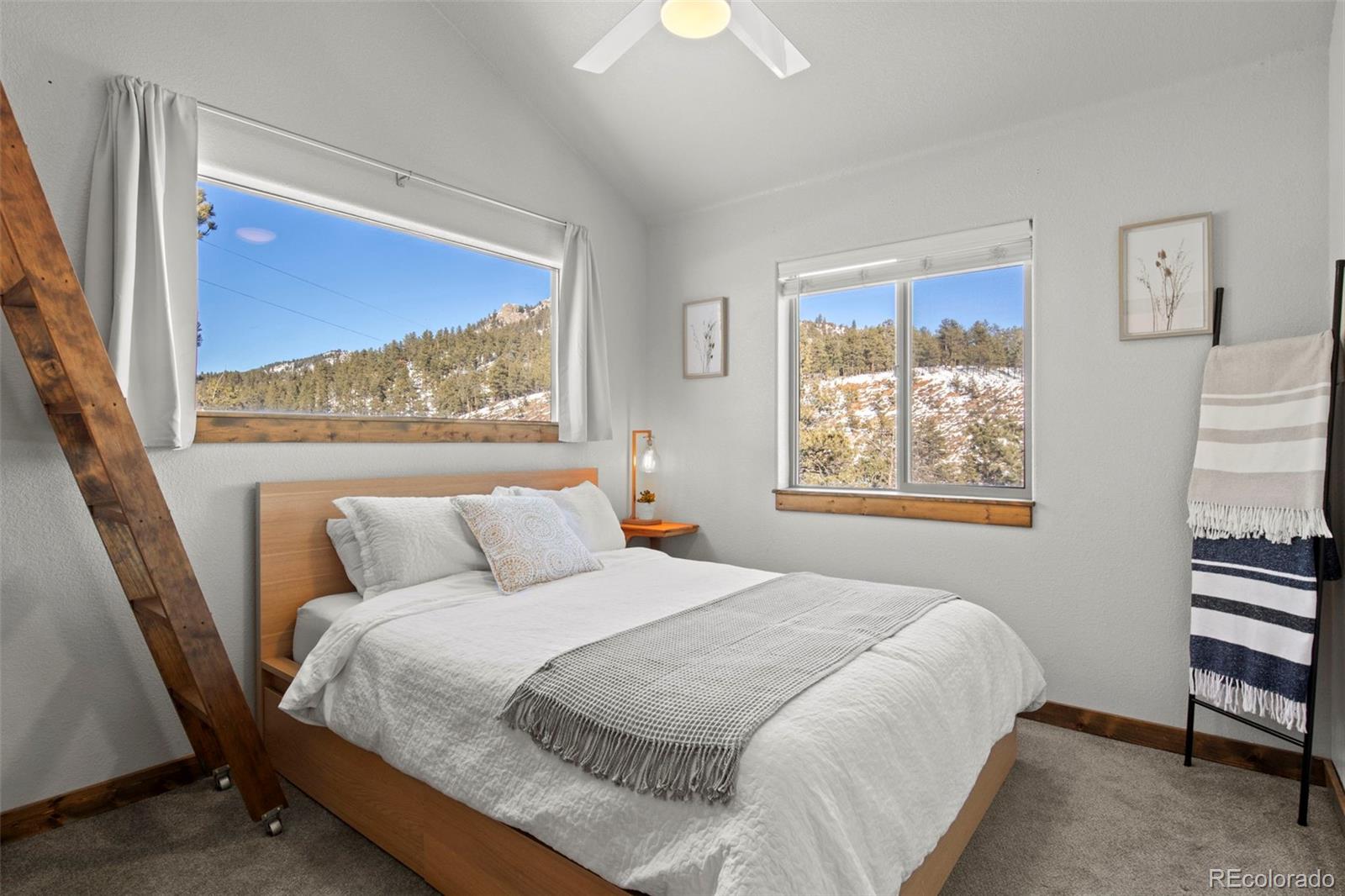 200 Virginia Road Bailey, CO 80421 - Photo 22 of 49 a bedroom with a bed and a painting on the wall