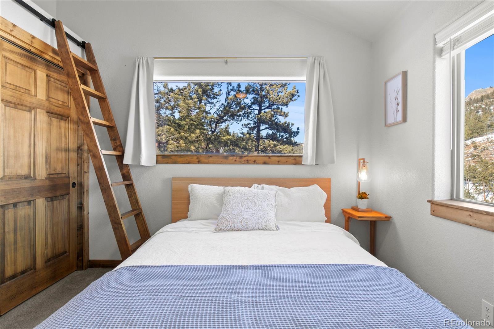200 Virginia Road Bailey, CO 80421 - Photo 24 of 49 a bedroom with a bed and a painting on the wall