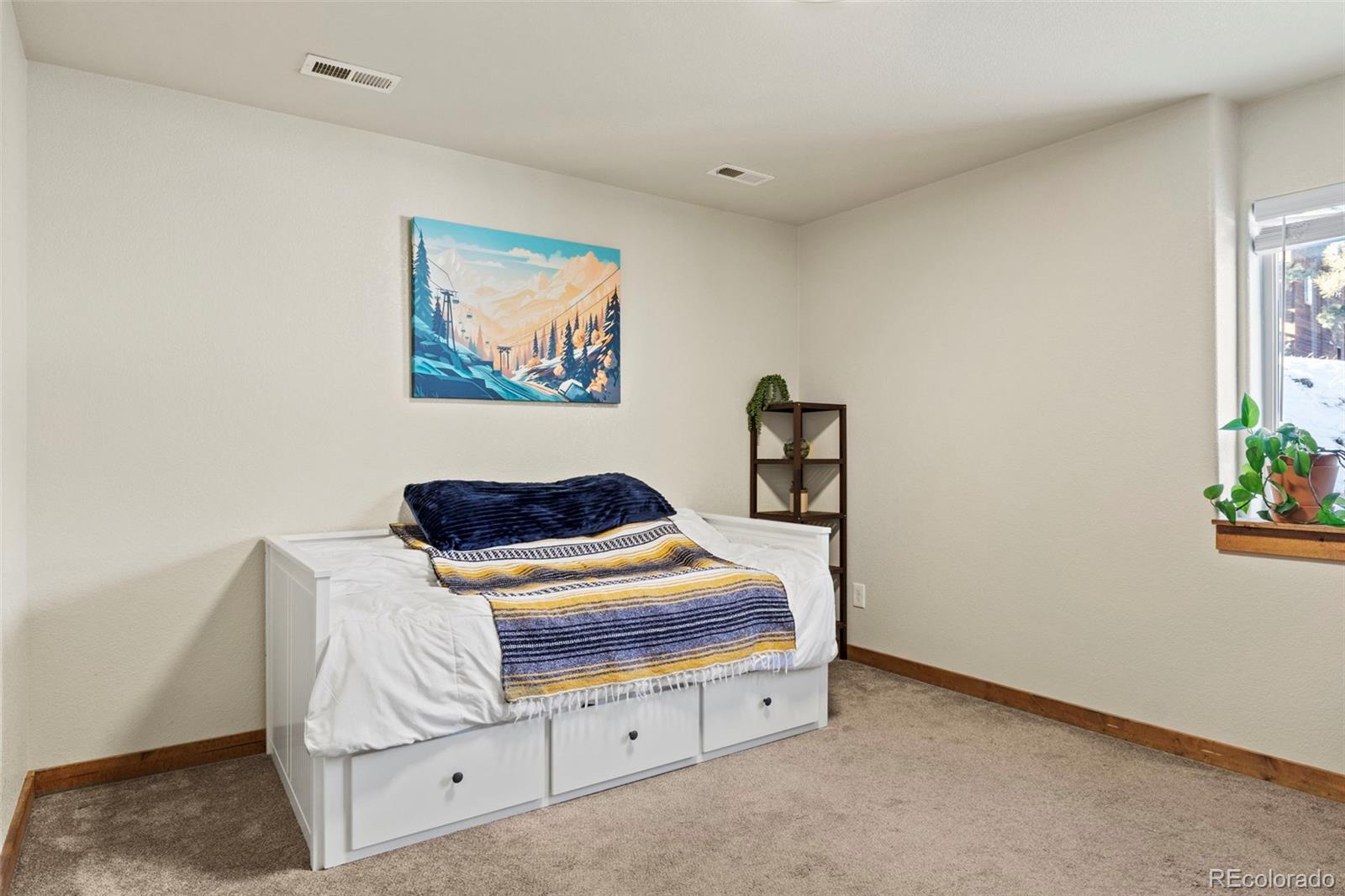 200 Virginia Road Bailey, CO 80421 - Photo 33 of 49 a bedroom with furniture and painting on the wall